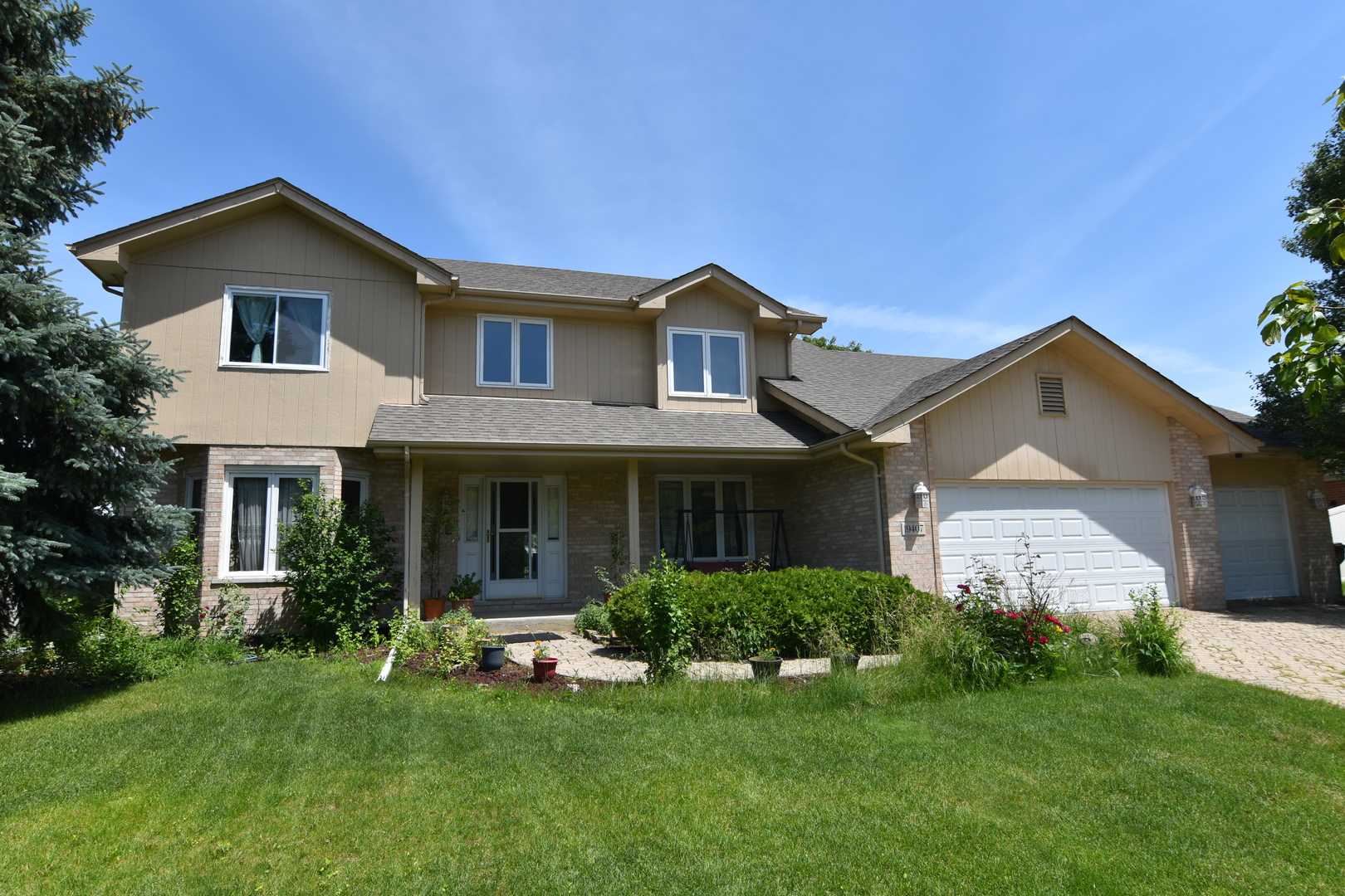 a front view of a house with a yard and porch