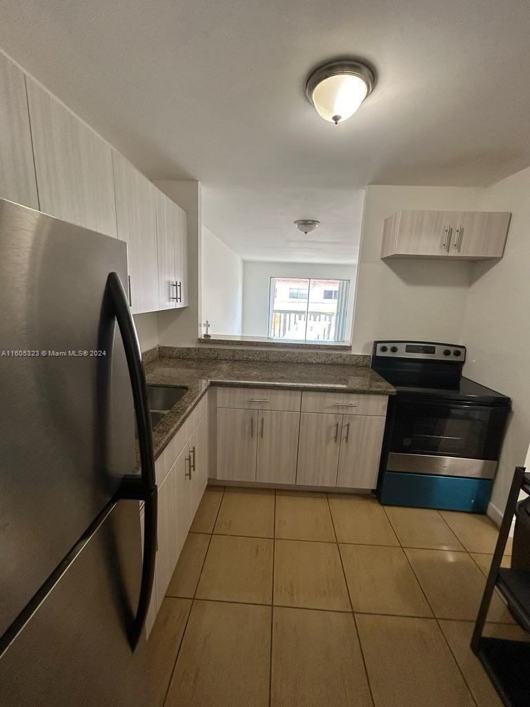 a kitchen with a sink a stove and refrigerator