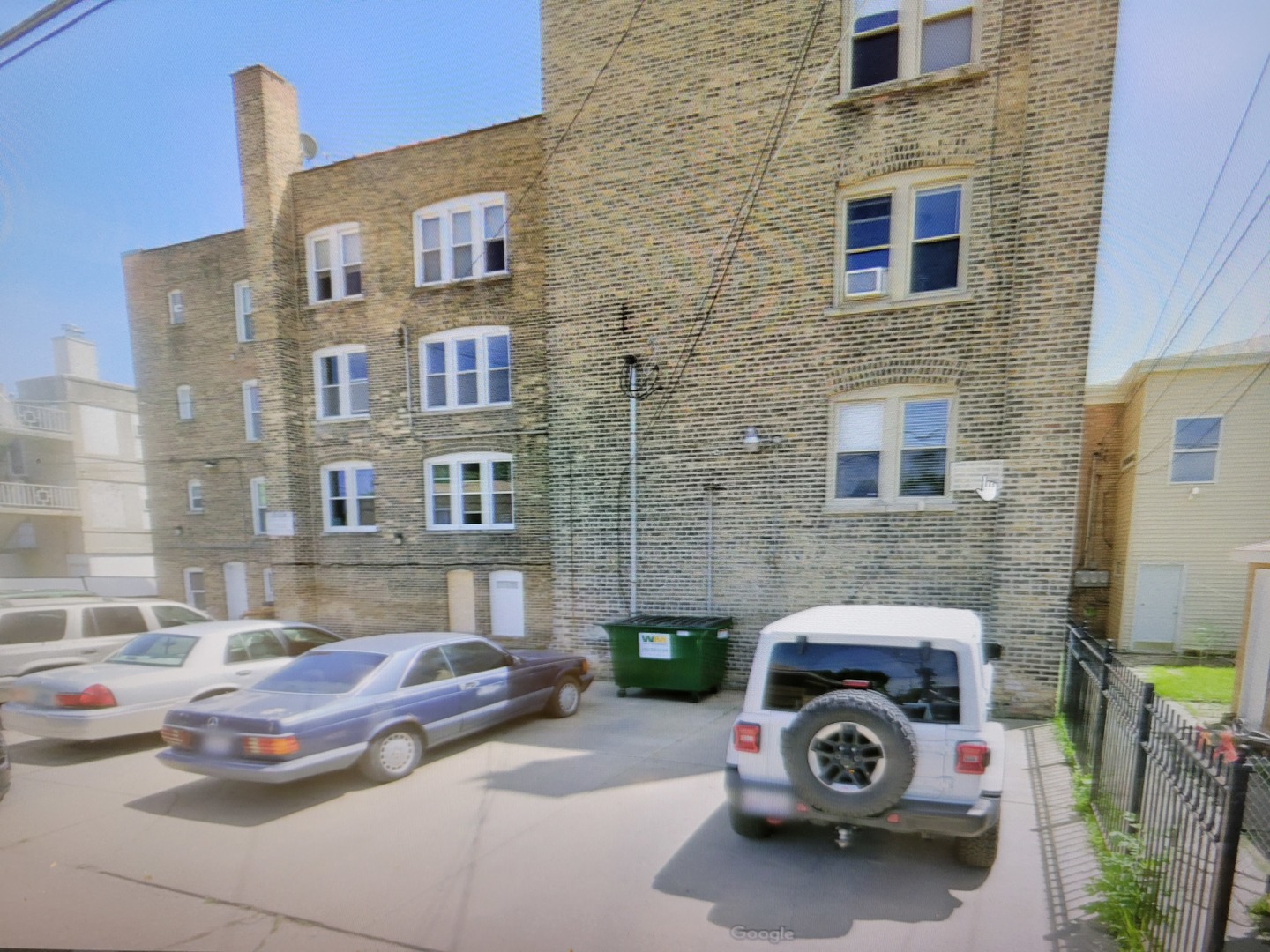 a car parked in front of a brick building