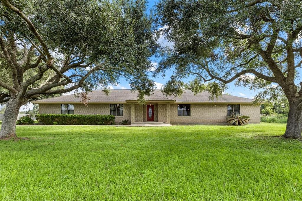 Front Of Custom Home With Mature Trees Across The Front.