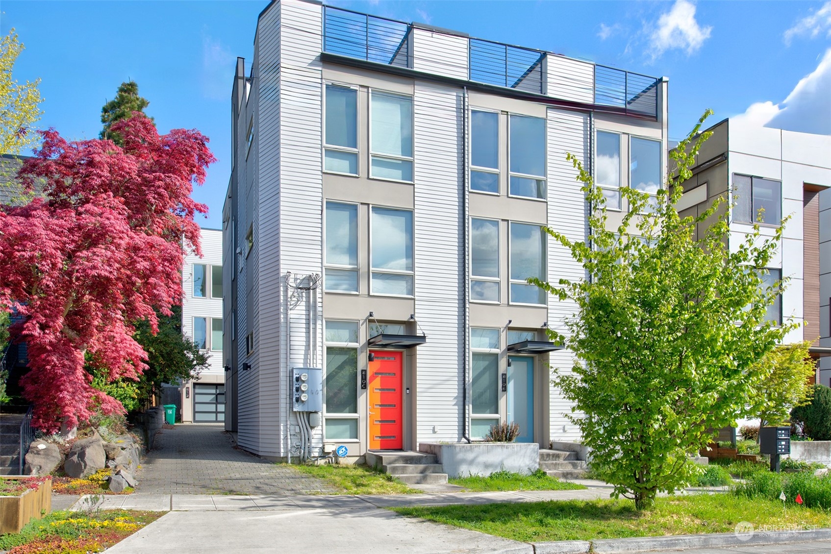 a front view of multi story residential apartment building with yard