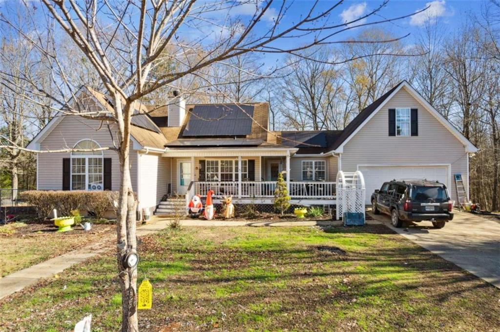 a view of a house with a yard patio and fire pit