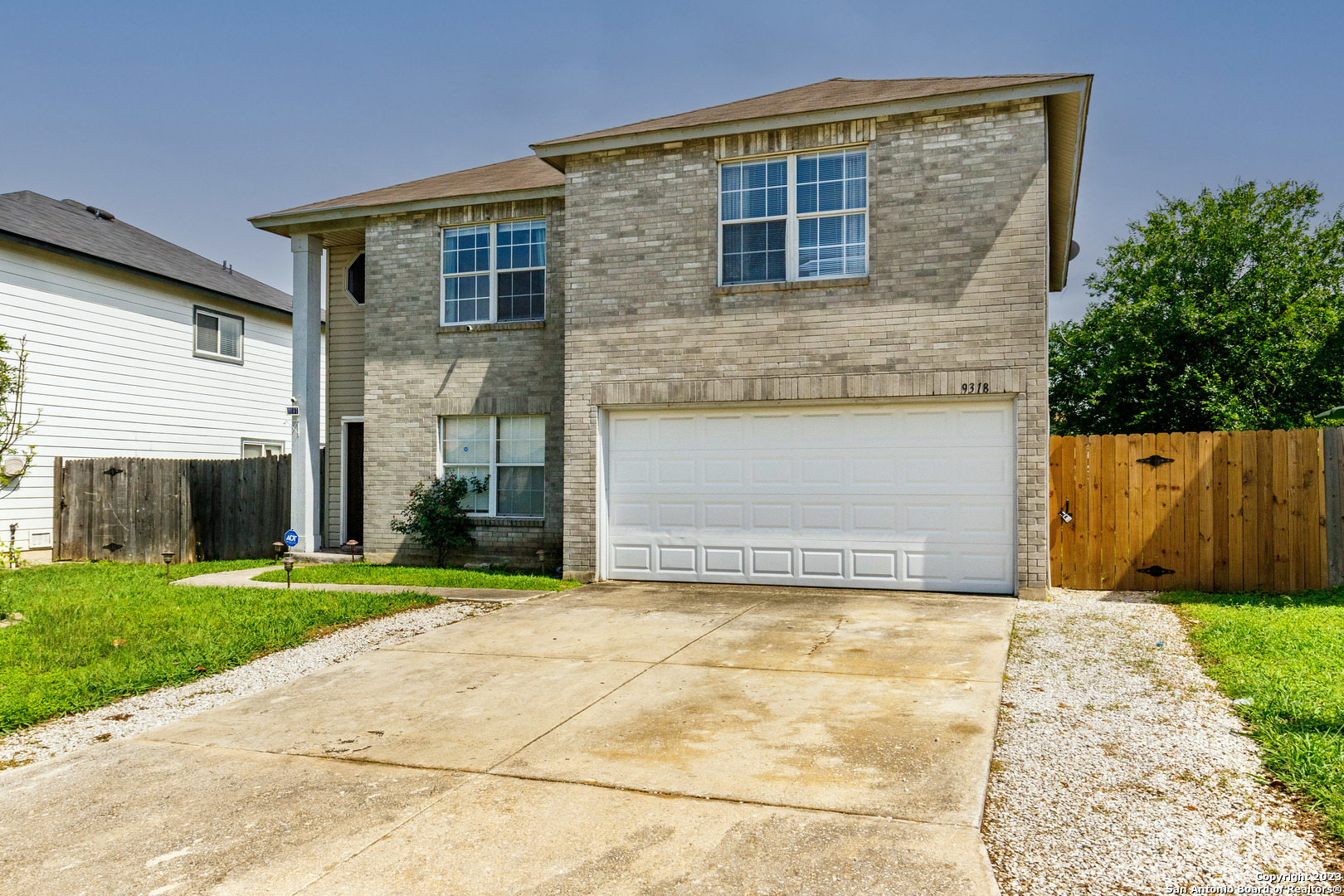 a view of backyard of house with garage