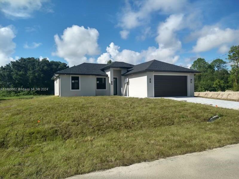 a view of a house with a backyard