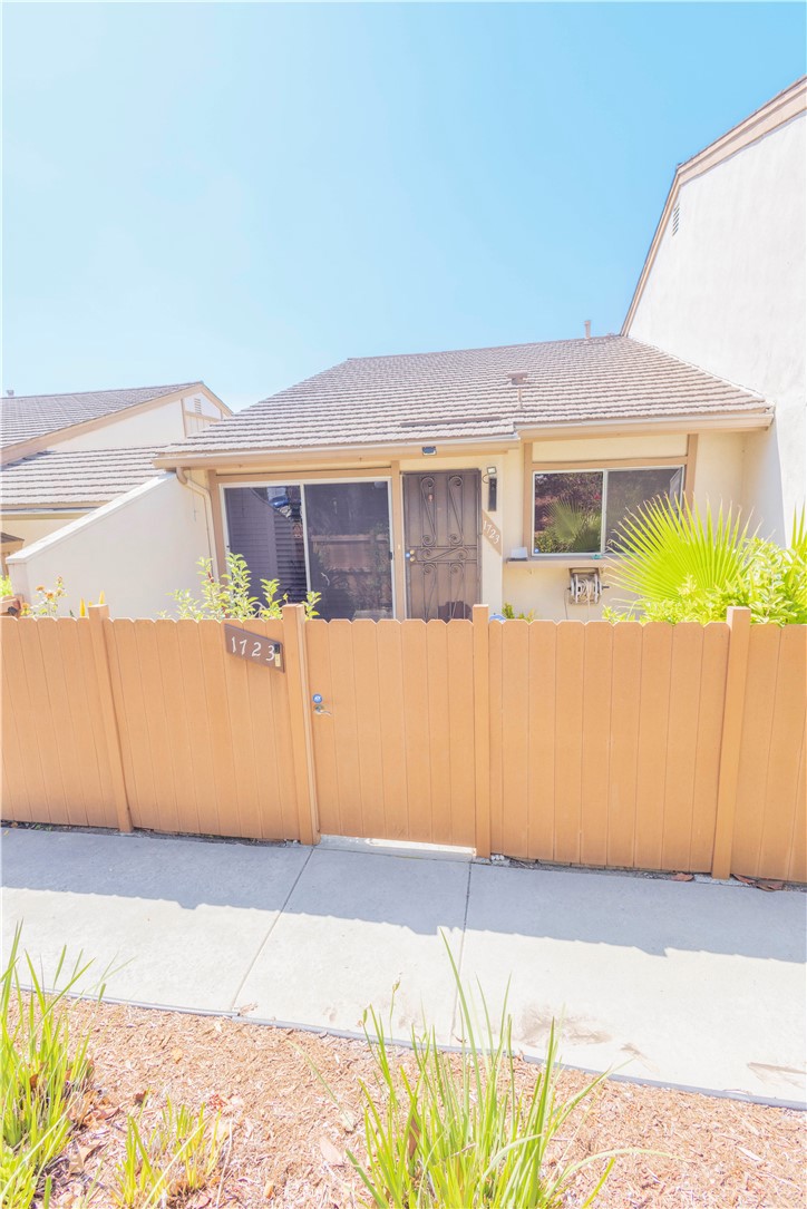 a view of a house with a wooden fence