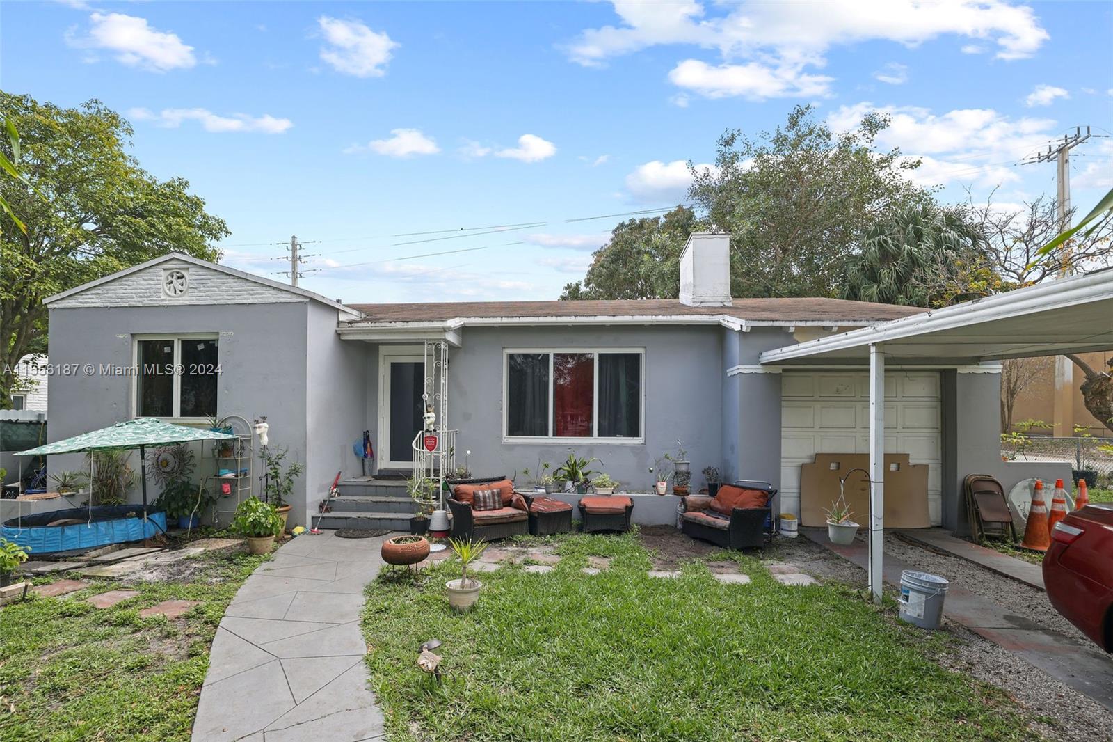 a view of a house with backyard sitting area and garden