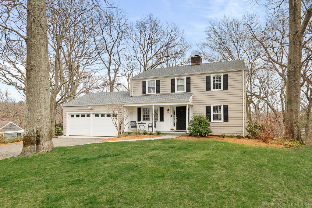 a front view of house with yard and green space