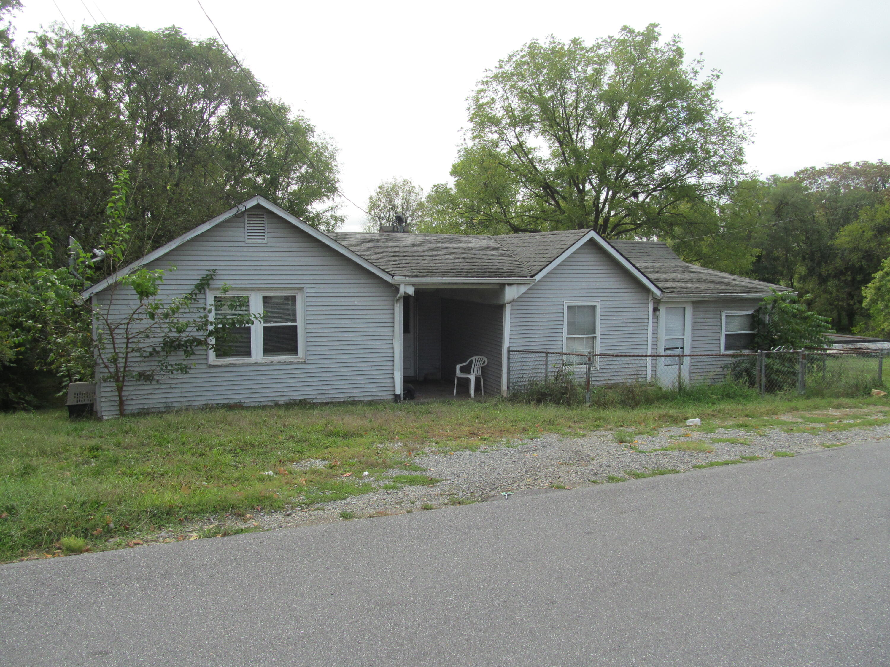 a front view of house with yard and trees