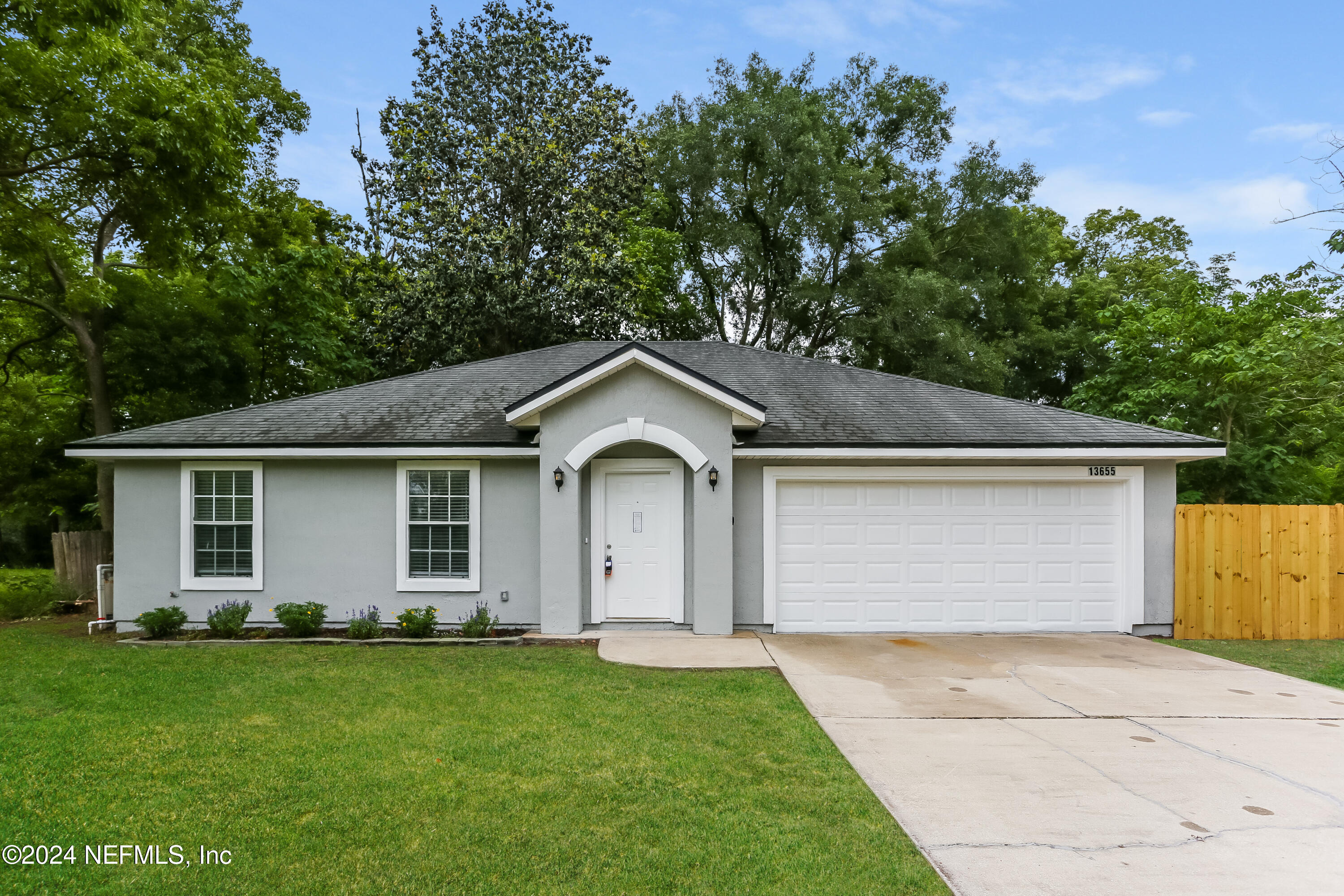 a front view of house with yard and green space