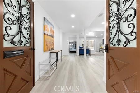 a view of a hallway with wooden floor