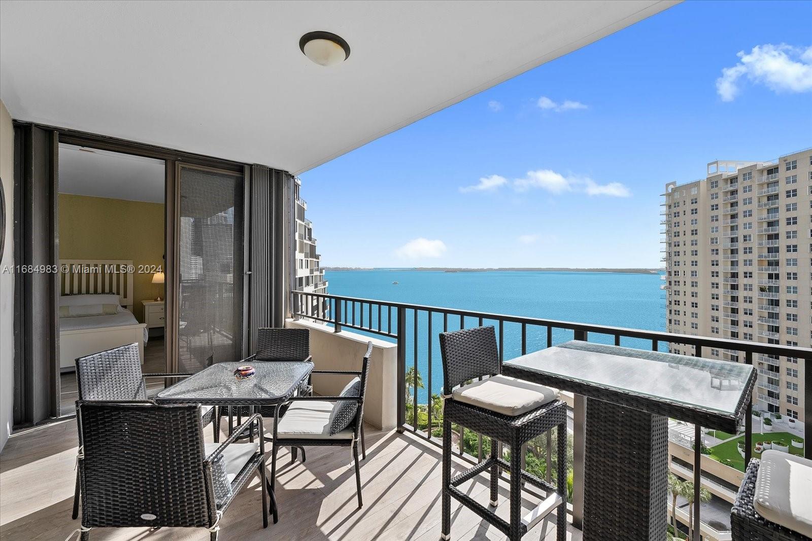 a balcony with a table and chairs