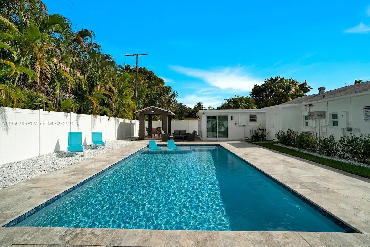 a house view with swimming pool and sitting space