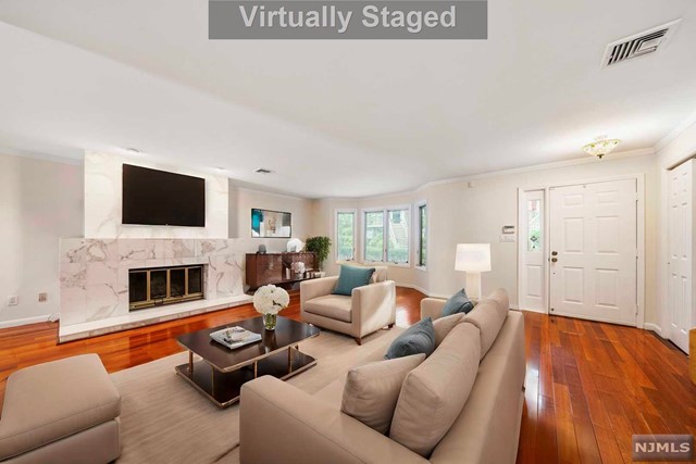 a living room with furniture flat screen tv and a fireplace