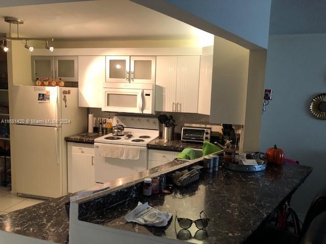 a kitchen with a sink stove and refrigerator