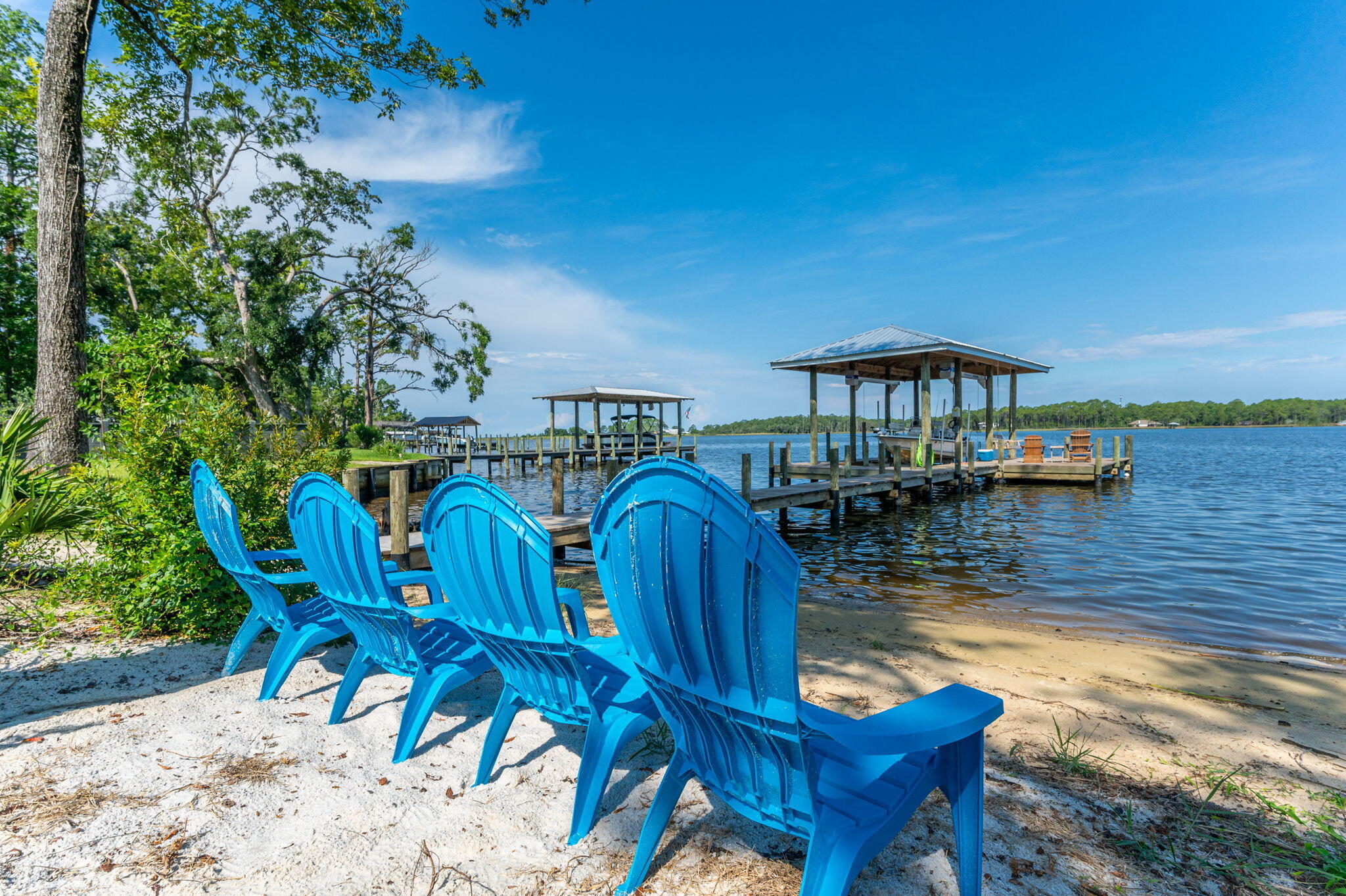 a view of a lake with a table and chairs