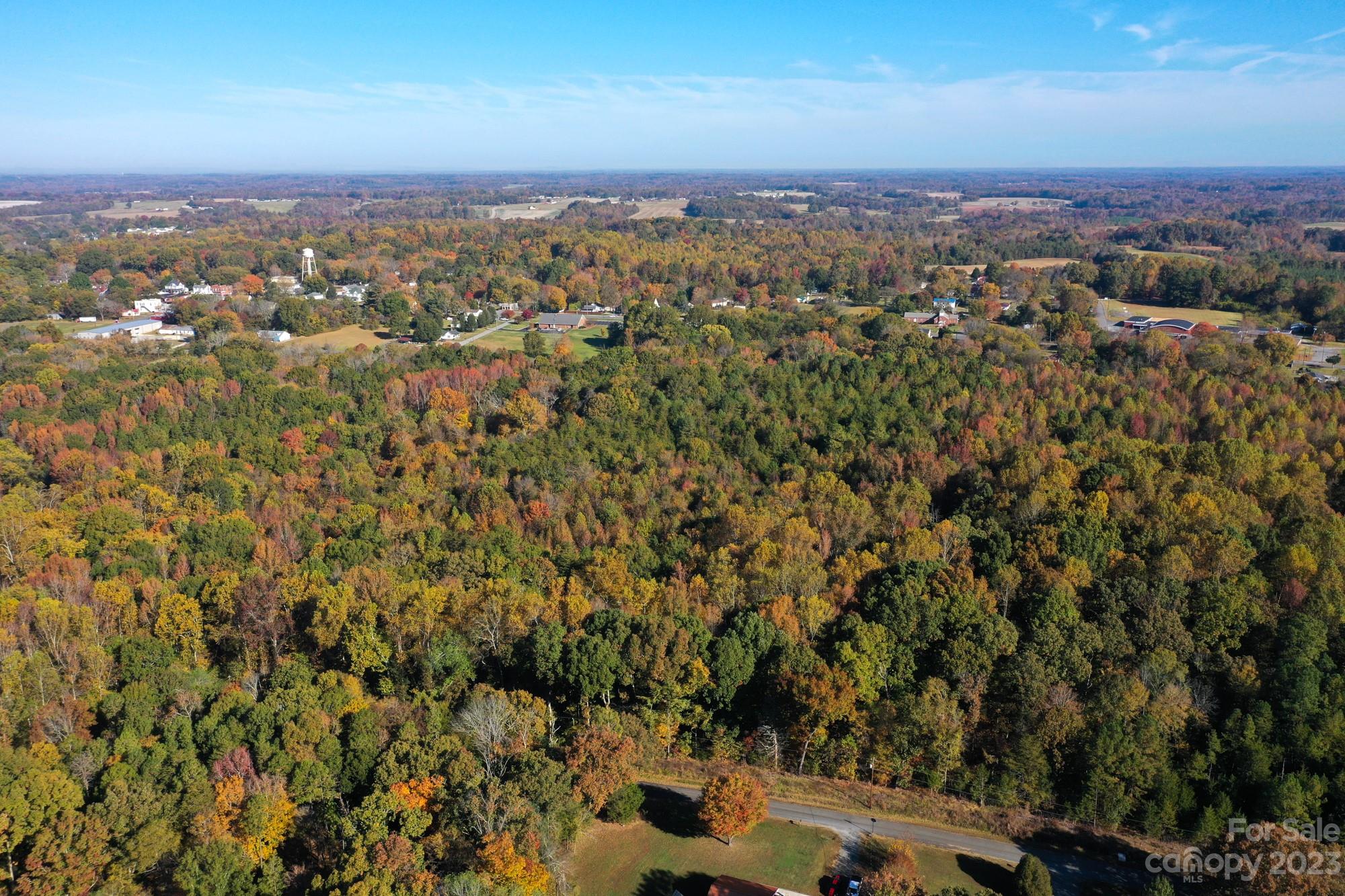 an aerial view of residential houses with city view