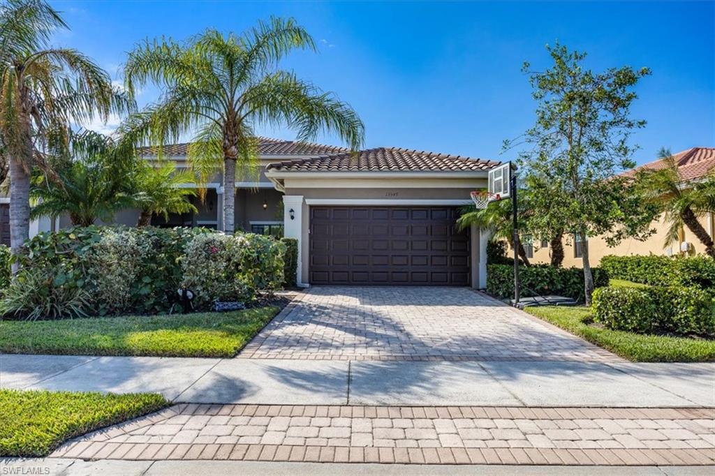 a front view of a house with a yard and garage