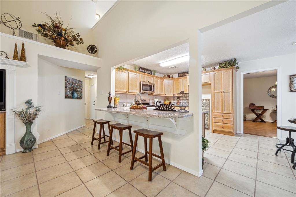 a kitchen with a sink and chairs