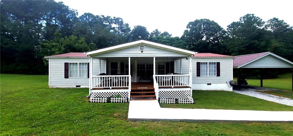 a view of a house with a yard and sitting area