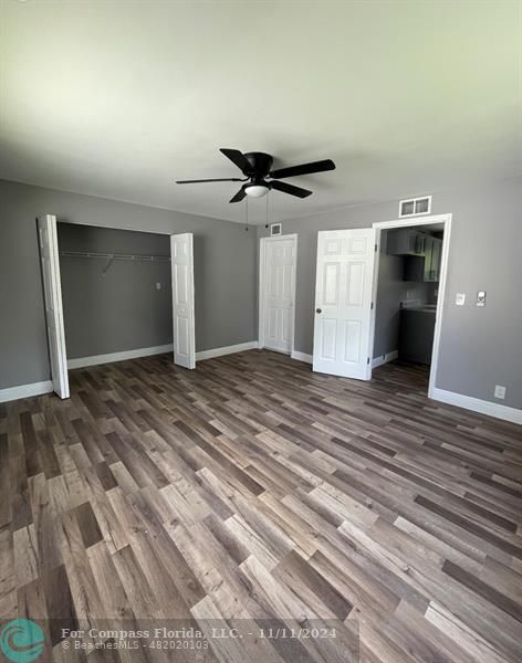 a view of a livingroom with a ceiling fan and window