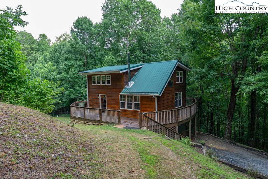 aerial view of a house with a yard and sitting area