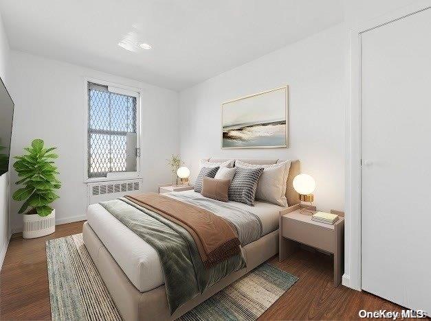 a bedroom with a bed and a potted plant