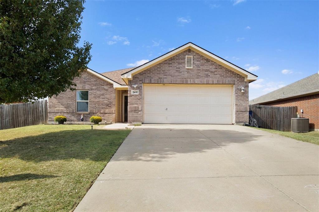 a front view of house with yard and garage