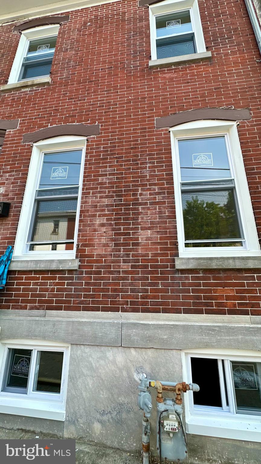 a brick house with a door and a chair