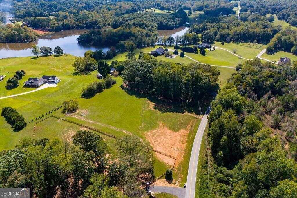 an aerial view of residential houses with outdoor space and swimming pool