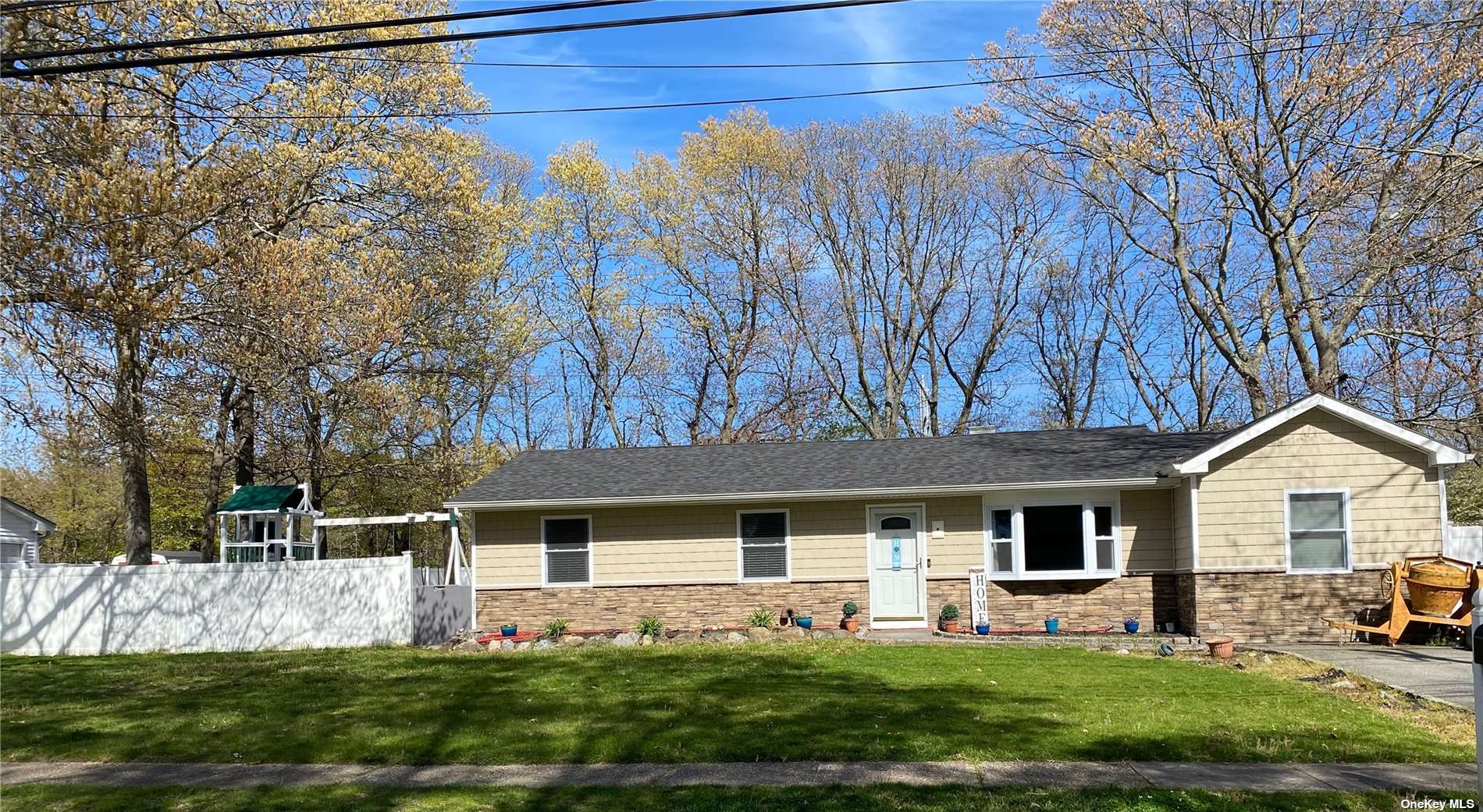 a front view of a house with a yard and trees