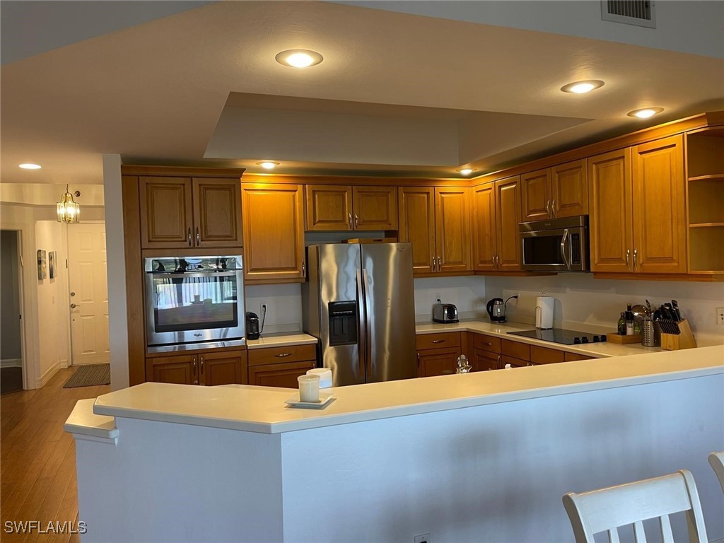 a kitchen with stainless steel appliances a refrigerator and a sink