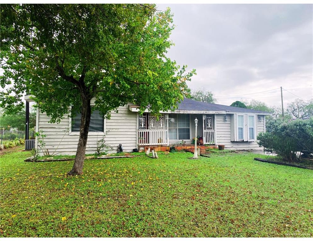 Single story home with a front lawn and cooling unit