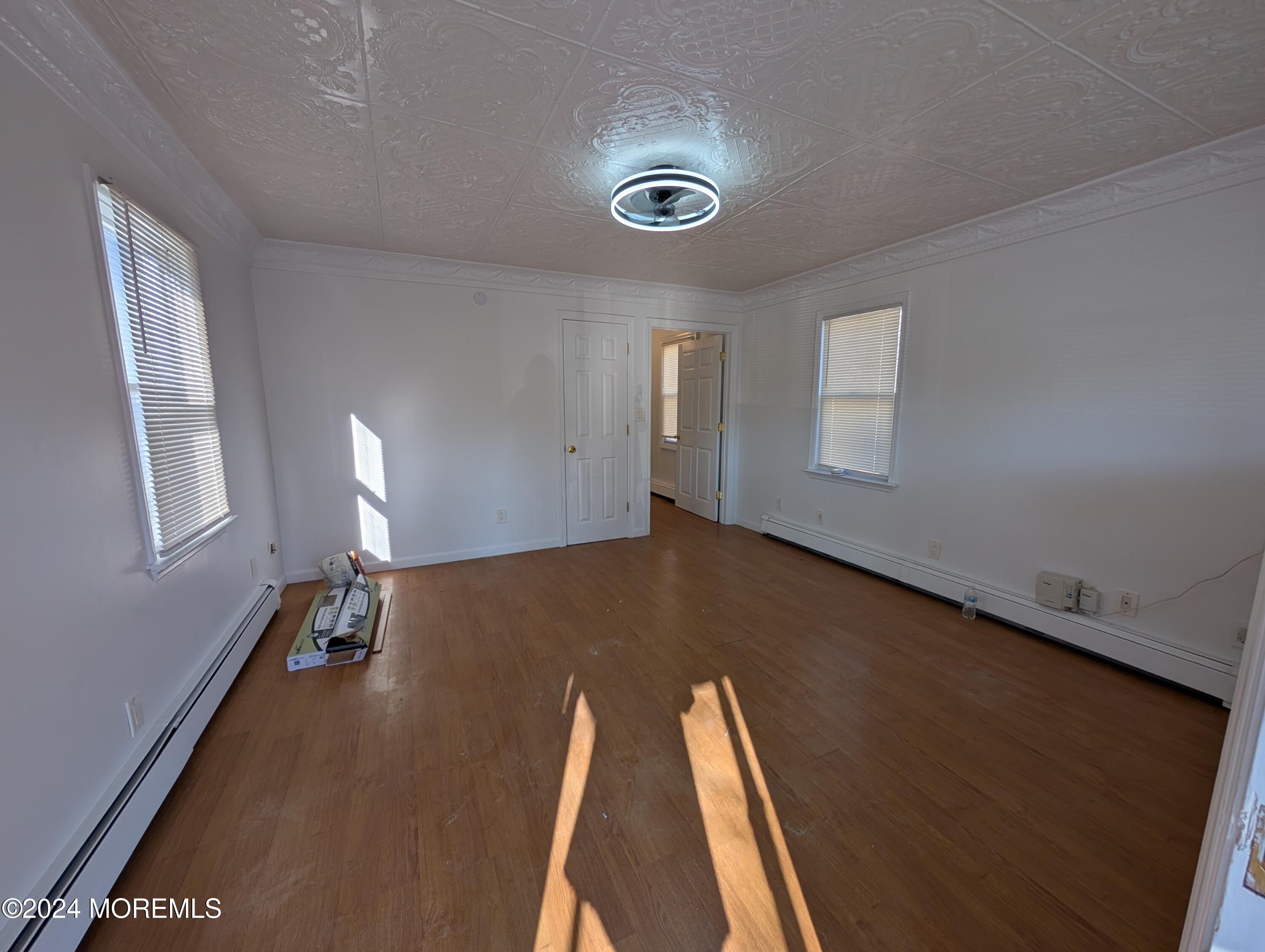 a view of room with window and wooden floor