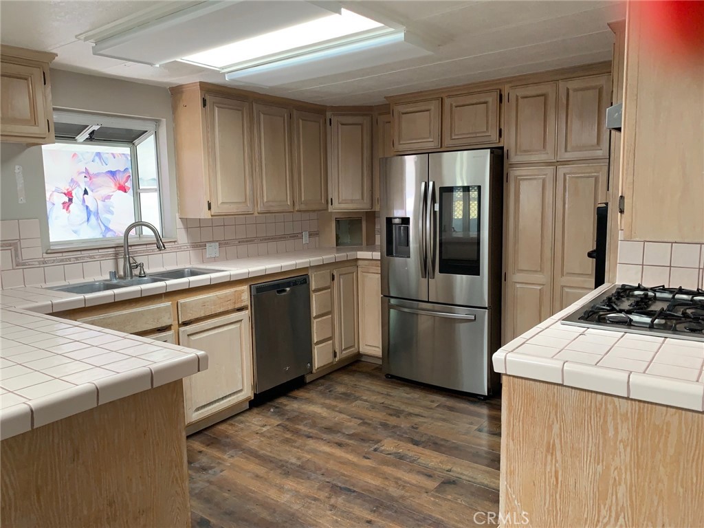 a kitchen with a sink stove and refrigerator