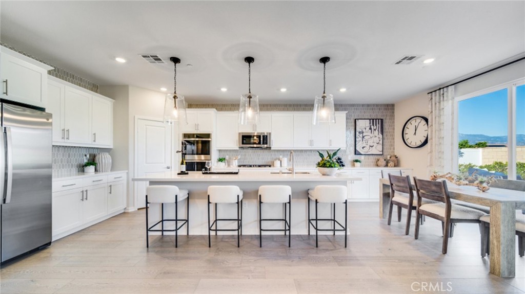 a large kitchen with a table and chairs