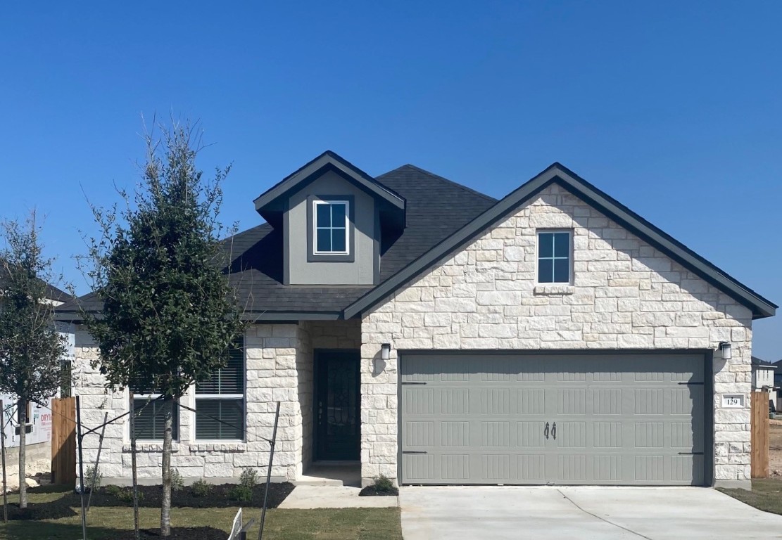 a front view of a house with garage