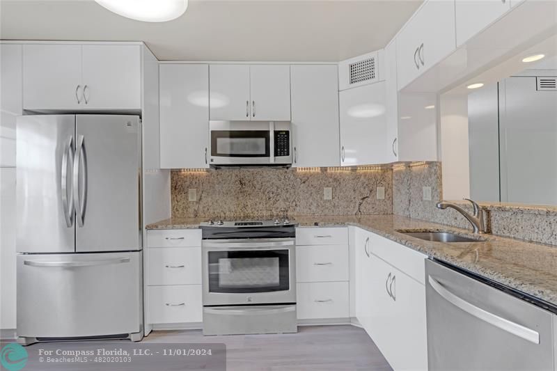 a kitchen with a sink stove and refrigerator