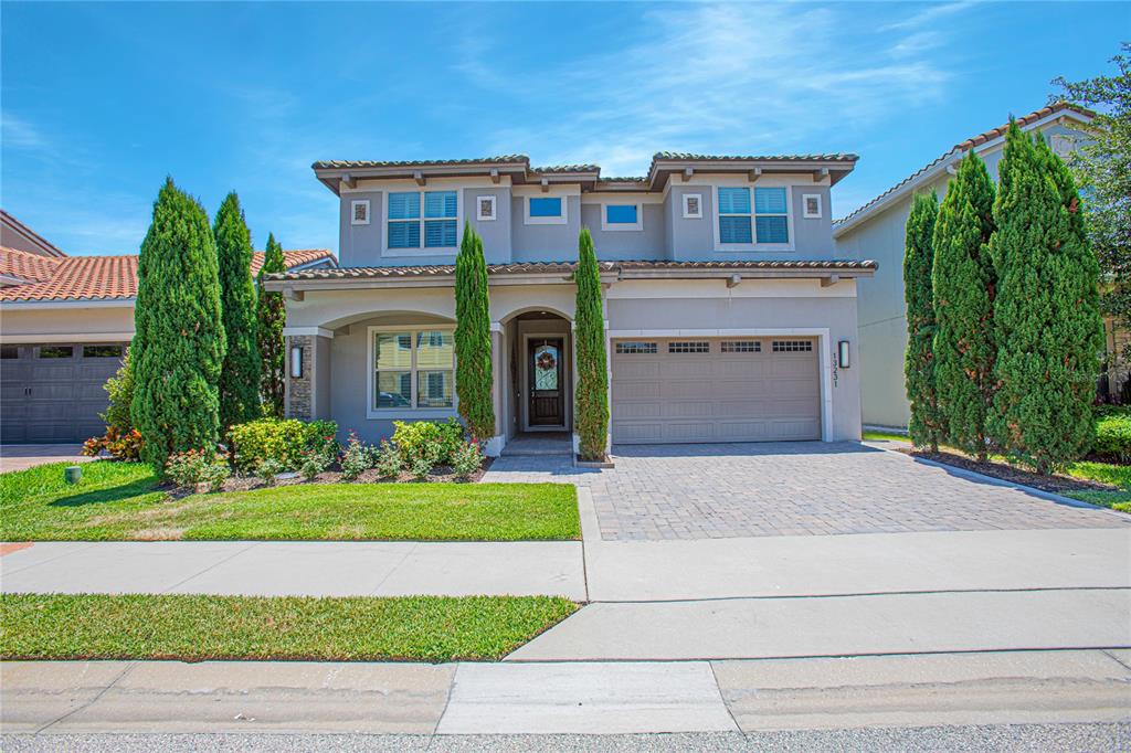 a front view of a house with a yard and garage