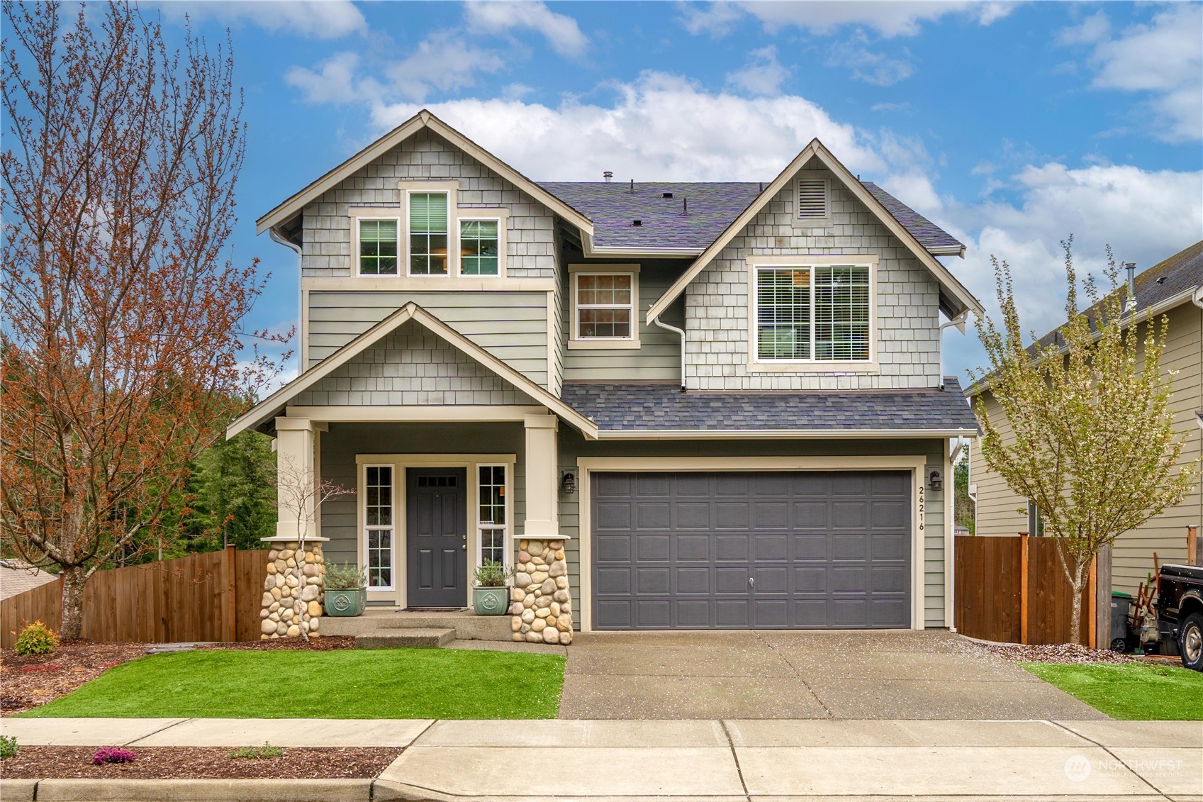 a front view of a house with a yard and garage