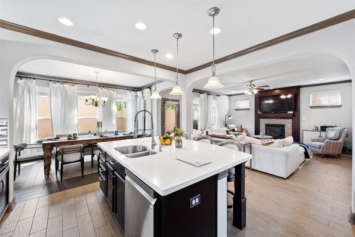 a kitchen with sink stove and living room view