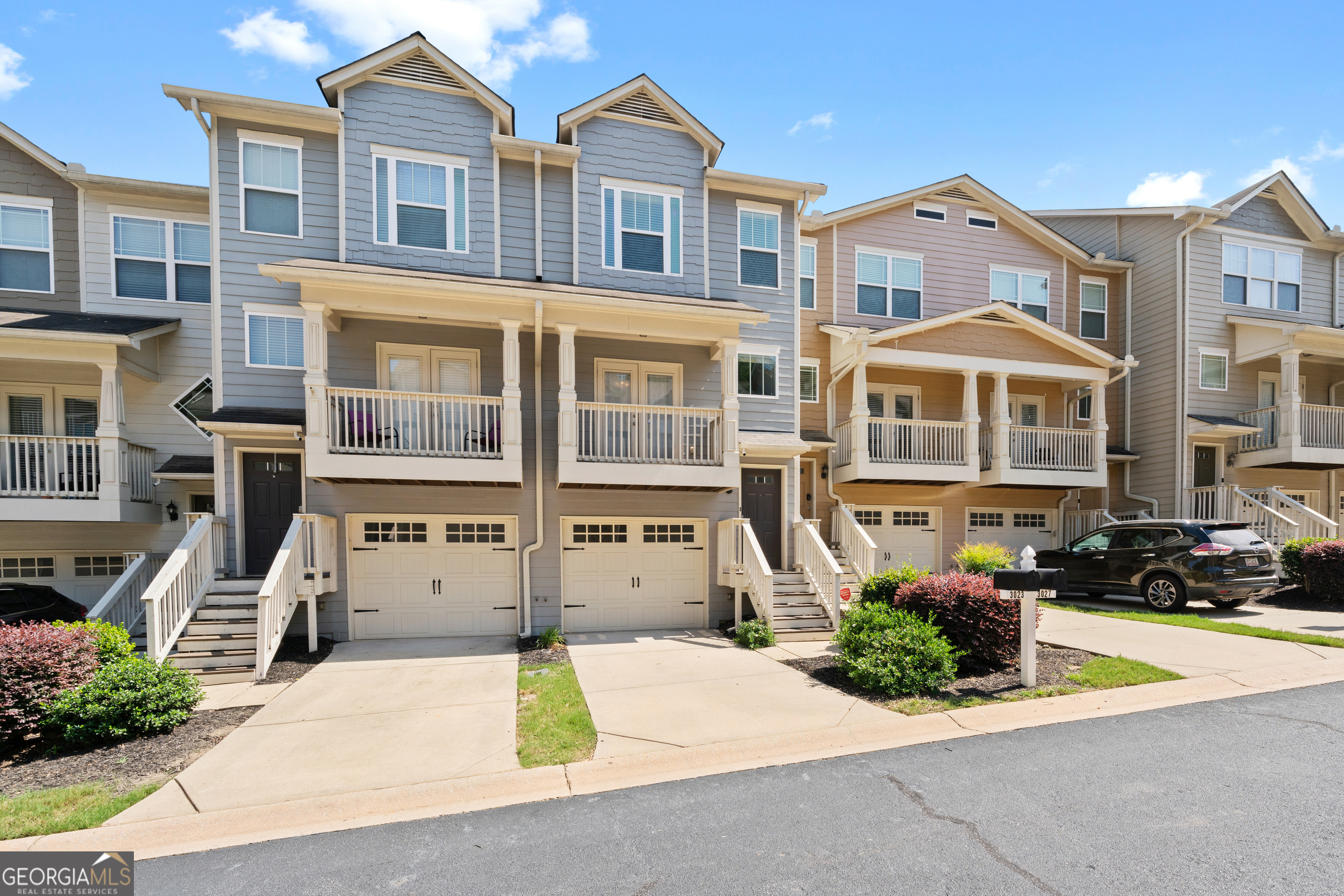 a front view of a residential apartment building with a yard