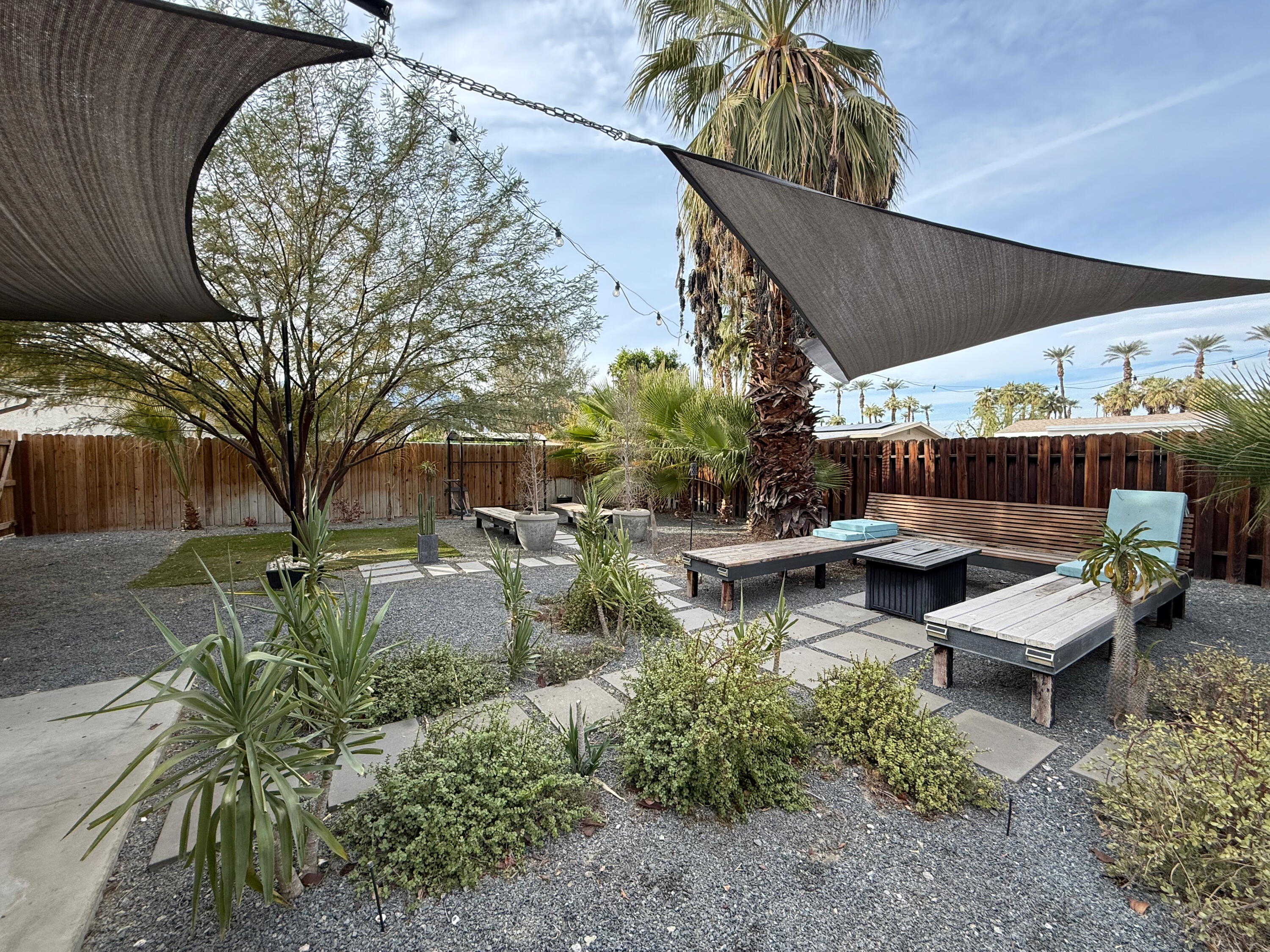 a view of a backyard with sitting area