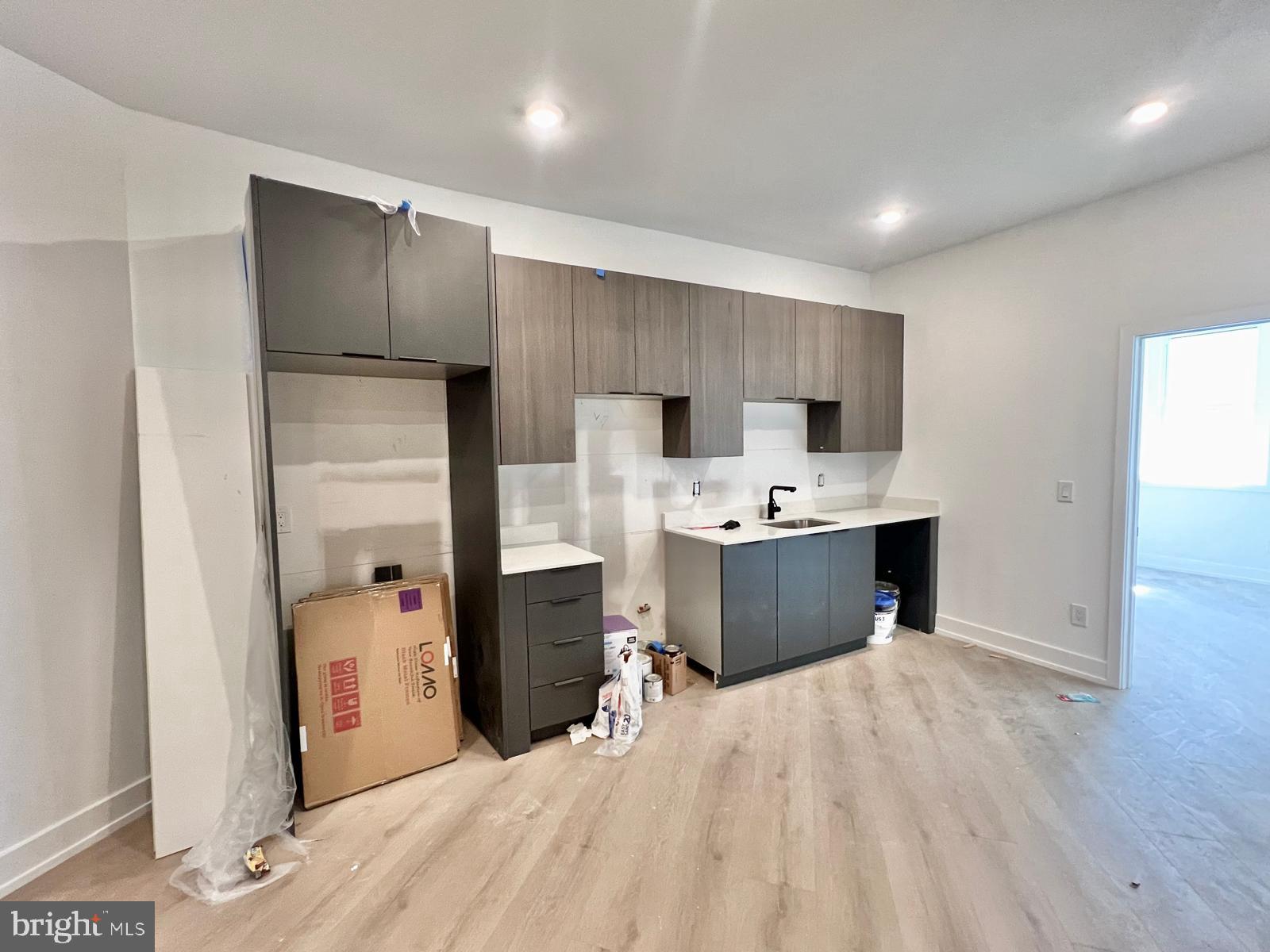 a kitchen with stainless steel appliances a sink a stove a refrigerator and cabinets