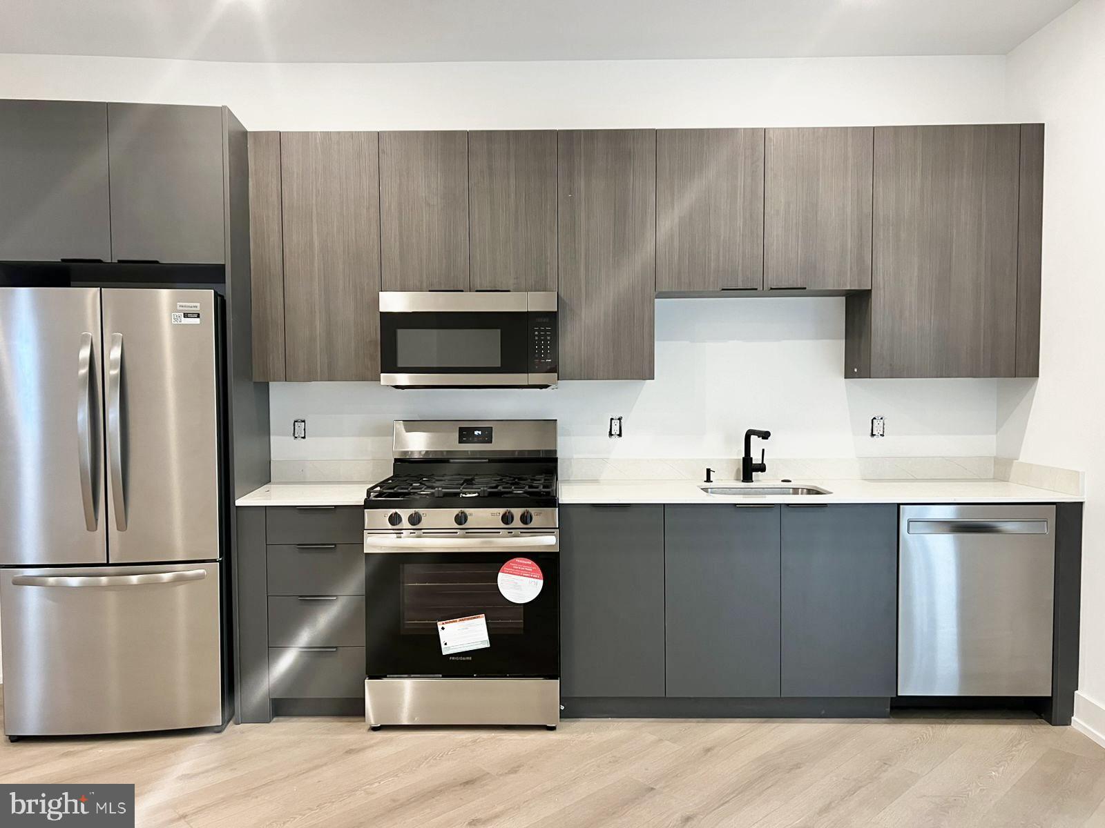 a kitchen with a sink a stove and refrigerator