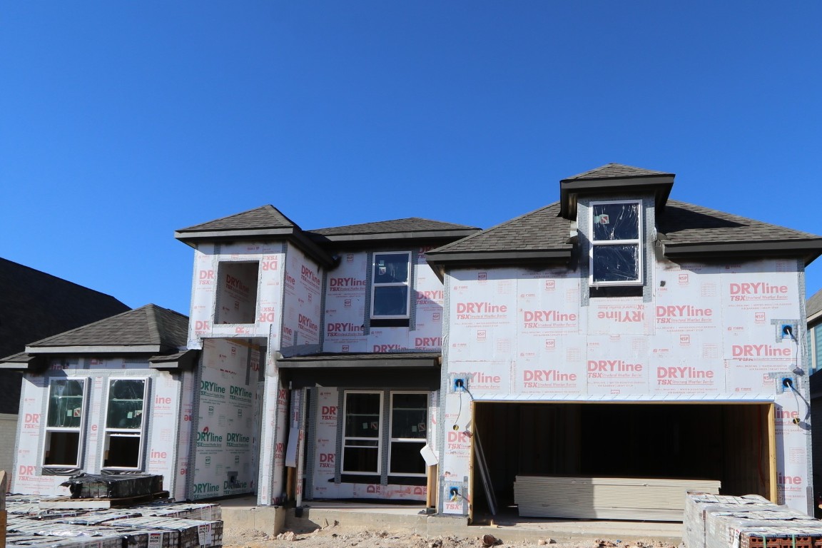 a front view of a house with parking space