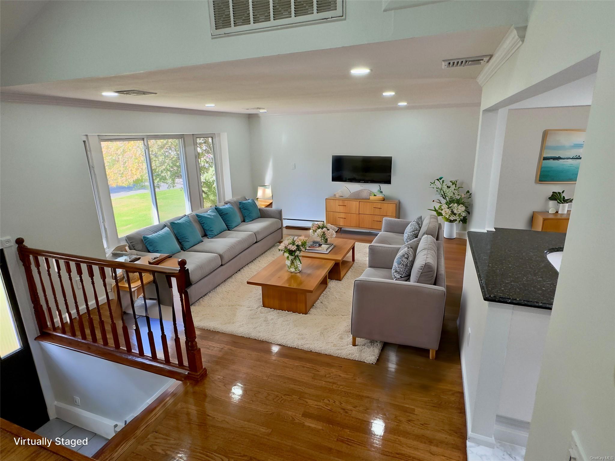 a living room with furniture and a flat screen tv