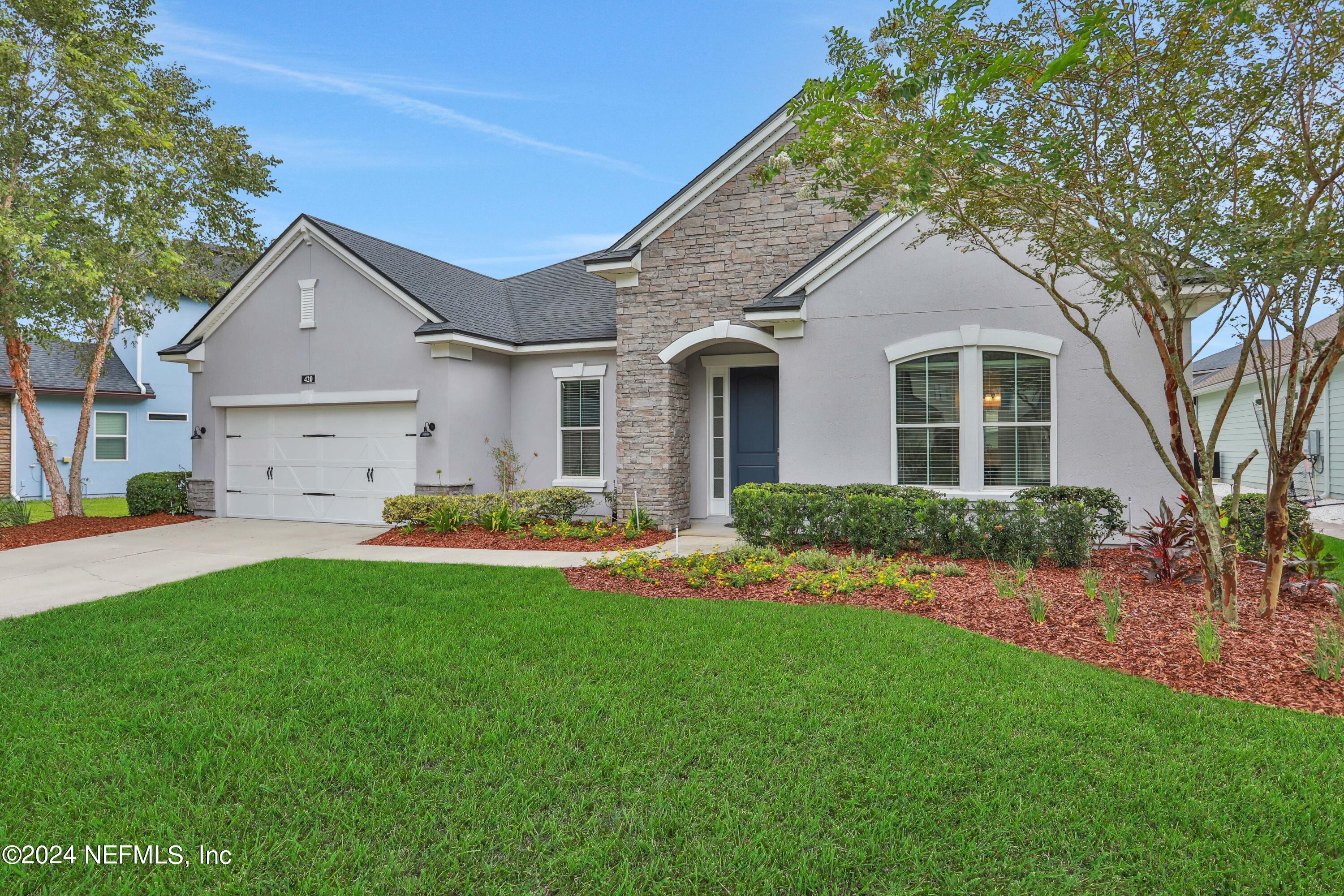 a front view of house with yard and green space