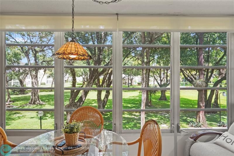 a room that has a lot of large windows and a dining table