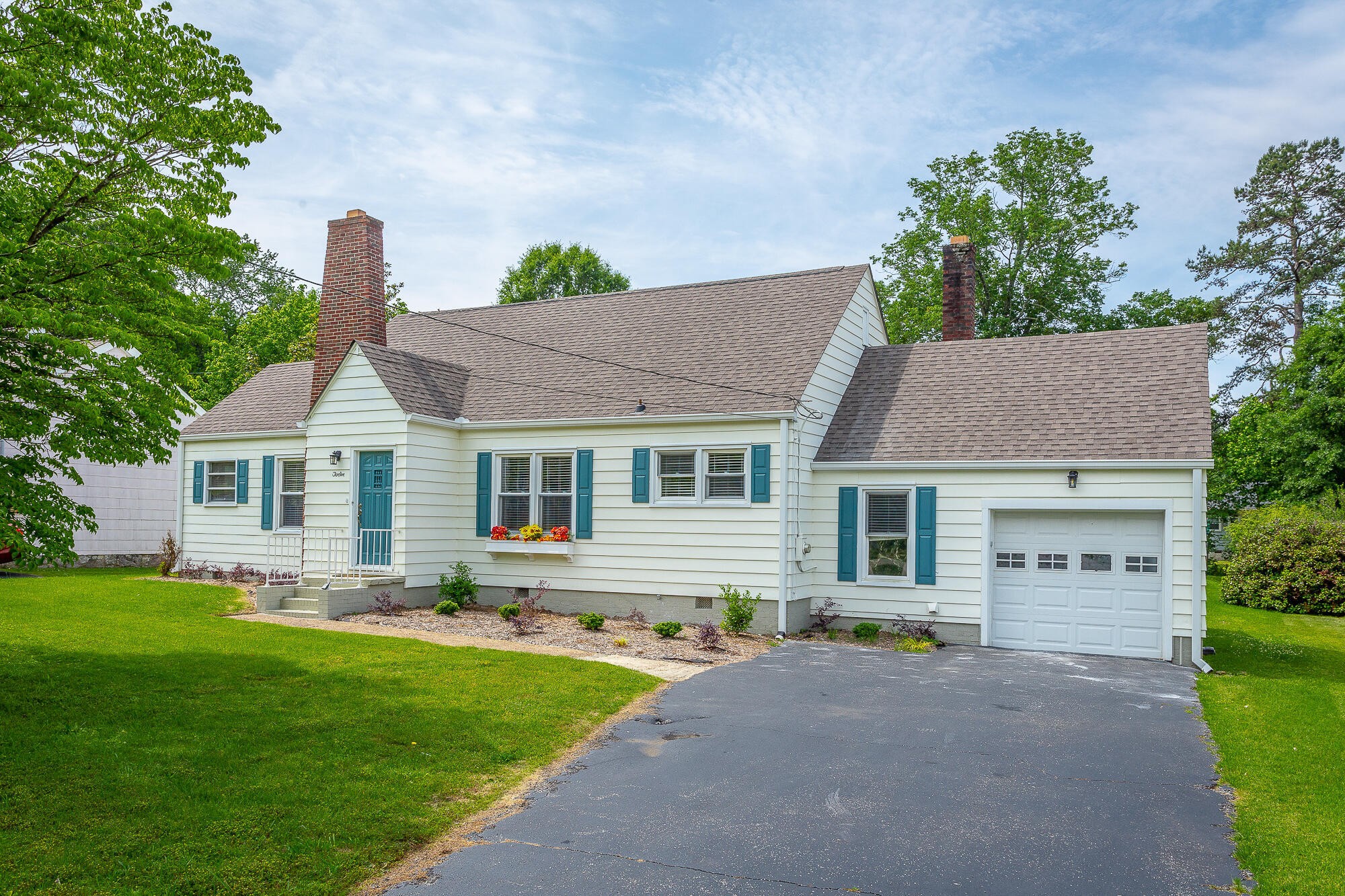 a front view of house with yard and green space