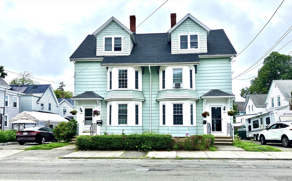 a front view of residential houses with yard